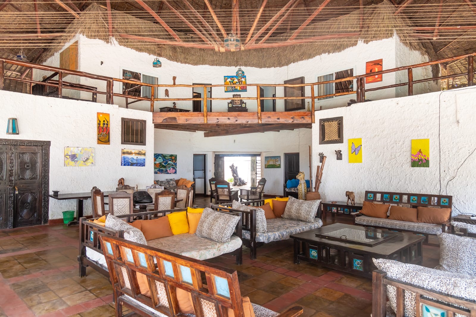Grand open-plan lounge with vaulted makuti ceiling